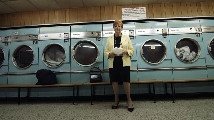 a great photo of a woman in the launderette of the barbican estate from a film produced by ila bêka and louise lemoine
