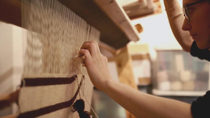photo of tapestry weaver christy balfour weaving in her studio