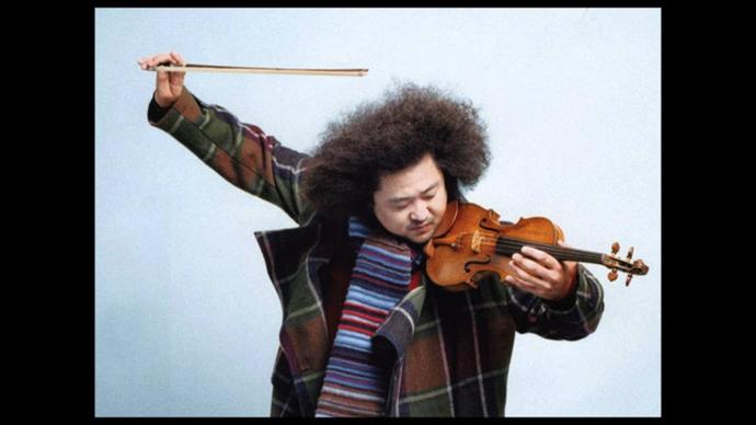 photo of a man playing the violin