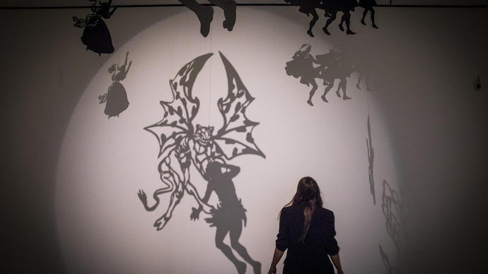 Silhouette of woman in a room full of shadows