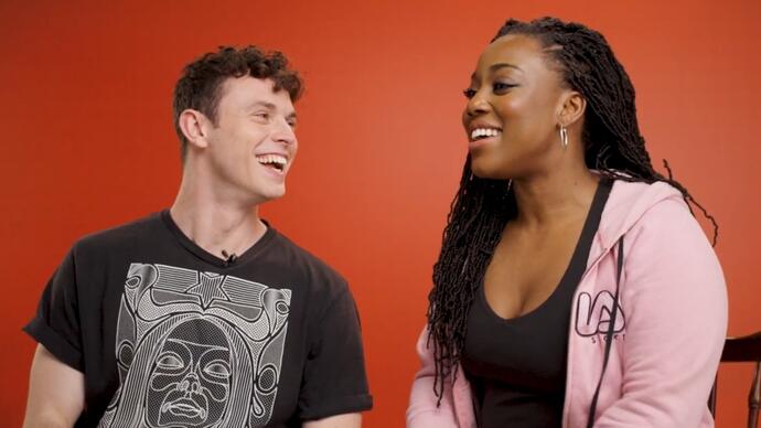 Charlie Stemp and Georgina Onuorah sit talking and laughing with each other.