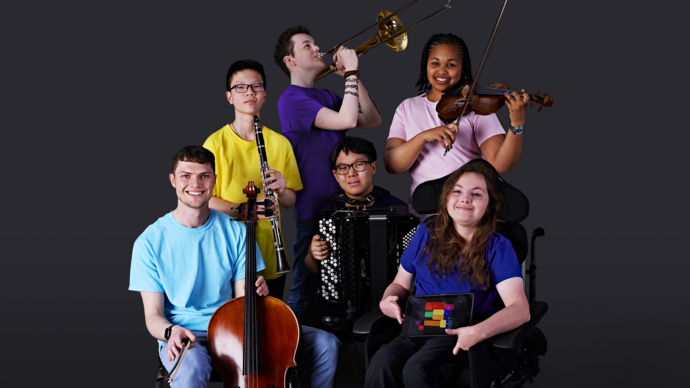 Musicians from the National Open Youth Orchestra posing with their instruments