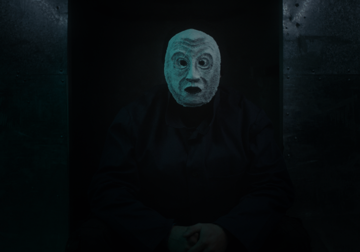 Dark image of a masked man