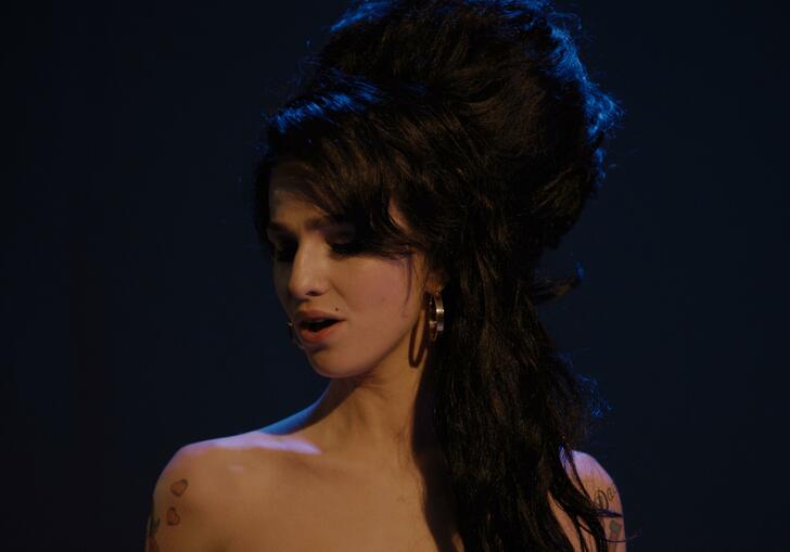 Amy Winehouse stands about to perform