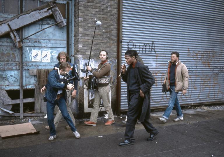 Photo of Basquiat and group of friends walking down a street