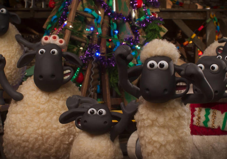 A still from Shaun the Sheep: The Flight Before Christmas - a group of sheep around a Christmas tree