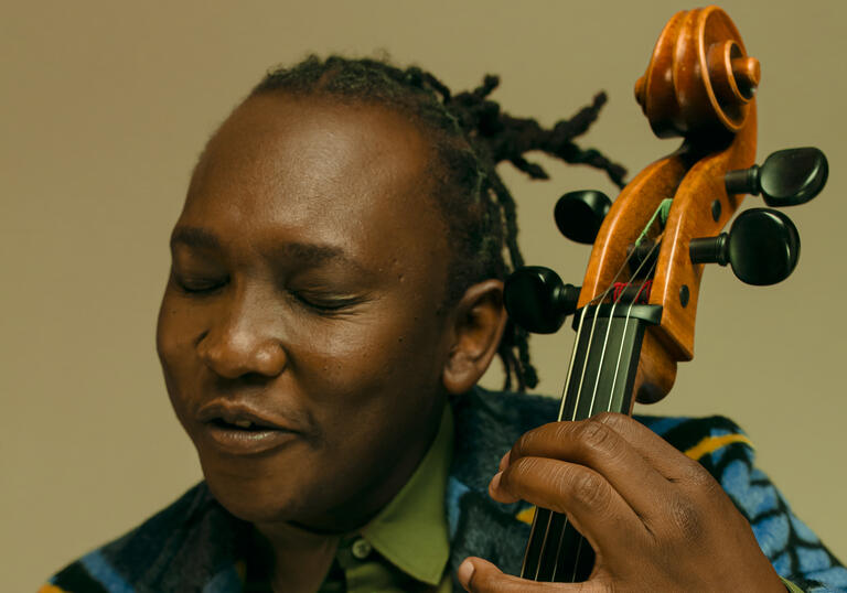 Close up photo of Abel Selaocoe playing his cello