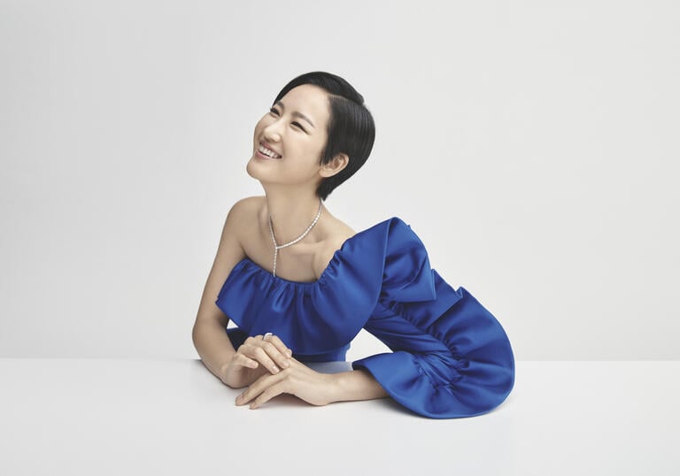 Hera Hyesang Park smiling against a white background