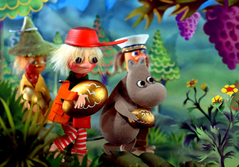 Moominpapa and a friend walk through a forest, holding golden eggs.