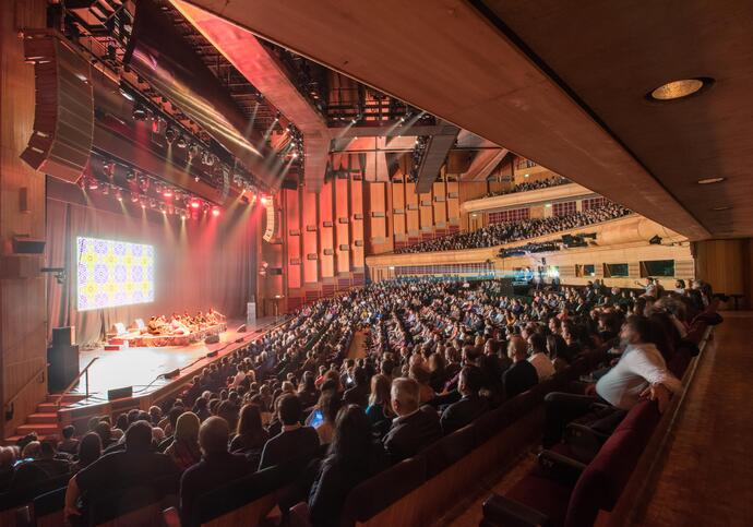 Photo of music performance and a full audience in the Barbican Hall