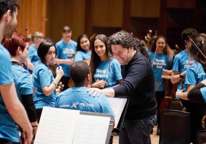 Gustavo Dudamel with young musicians from the Young Orchestra East