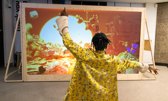 Person dancing in front of installation