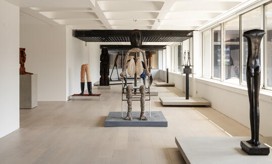 A shot of the gallery, showing sculptures by Giacometti and Huma Bhabha.