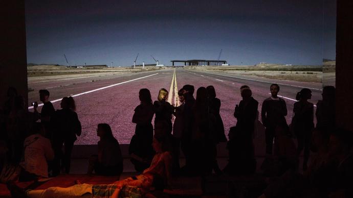 Photo of crowd watching a film screen