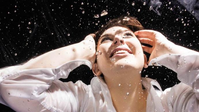 photo of a woman smiling in water