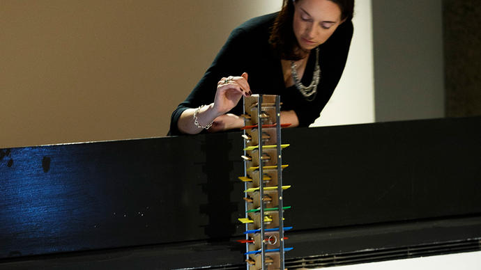 Woman playing with a musical tower