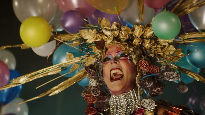 photo of taylor mac with rainbow balloons