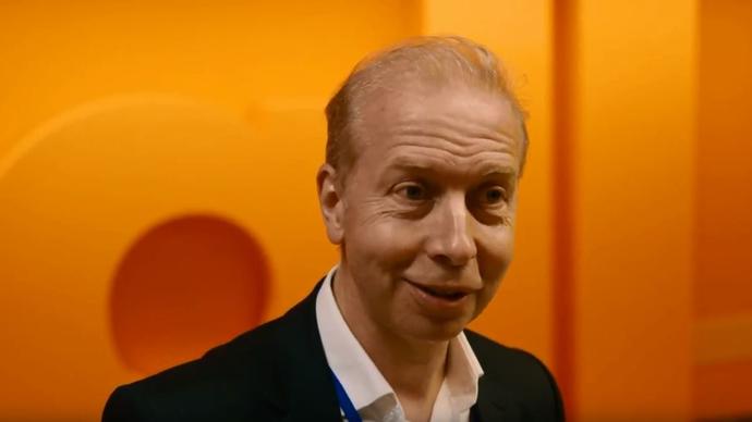 photo of david butcher in front of an orange wall