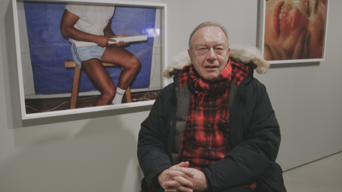 photo of swiss photographer walter pfeiffer in front of his own photos