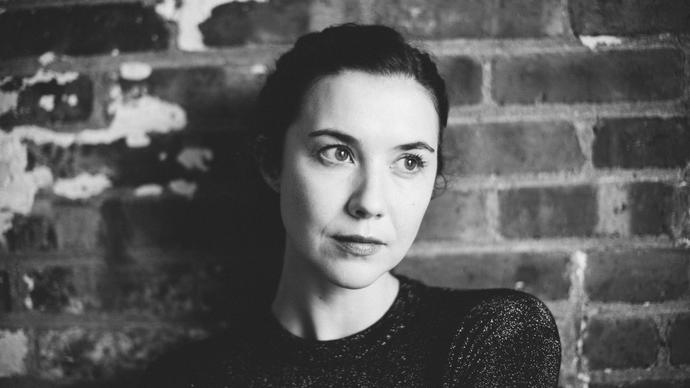 Lisa Hannigan standing in front of a brick wall