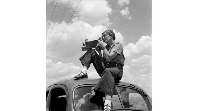 Dorothea Lange with a camera on a truck