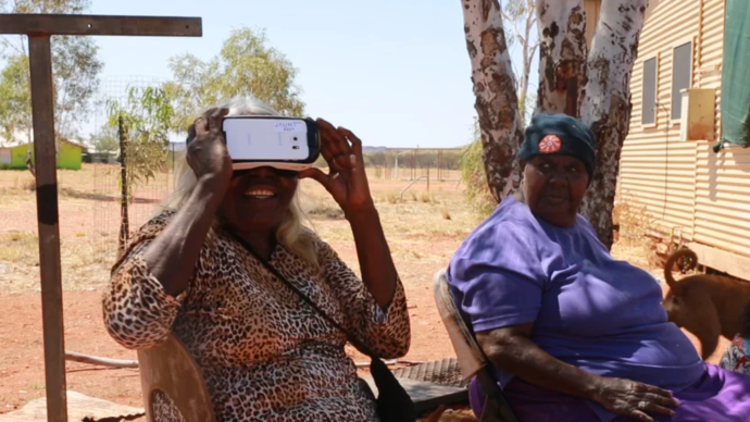 photos of two women looking at Vr headset 