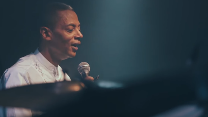 photo of jeff mills wearing a white shirt holding a microphone