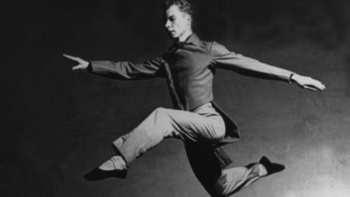 black and white photo of merce cunningham jumping