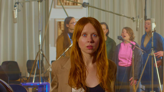 Holly Herndon in front of a choir recording