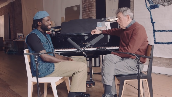 photo of dev hynes and philip glass in front of a piano