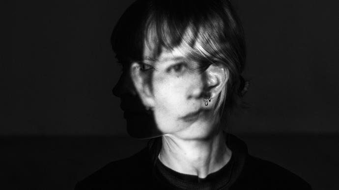 A black and white photo of Jenny Hval with her face distorted