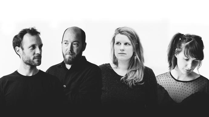 Echo Collective wearing black clothing against a white background