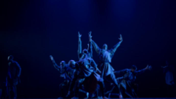 people dancing in a blue light