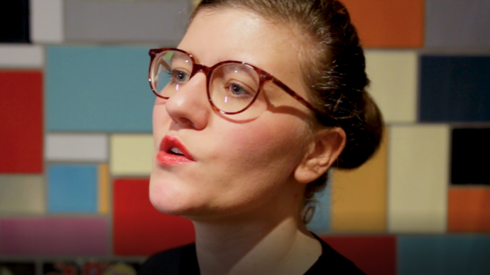 photo of a woman wearing glasses talking to the camera