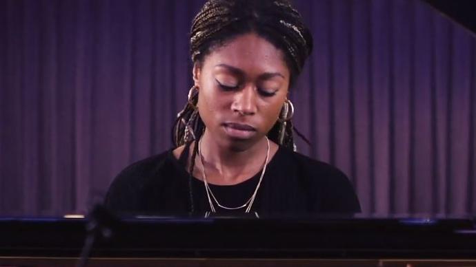 Photo of Isata Kanneh-Mason playing the piano 