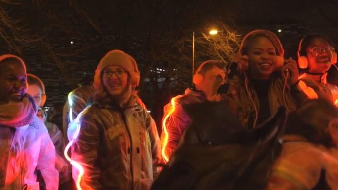 Photo of young people dressed up with lights