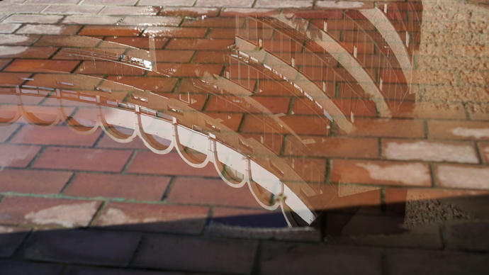 photo of the barbican reflected in a puddle