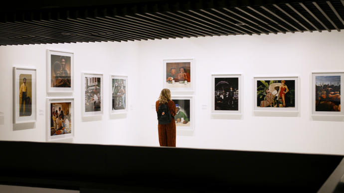 Woman looking at photo in gallery