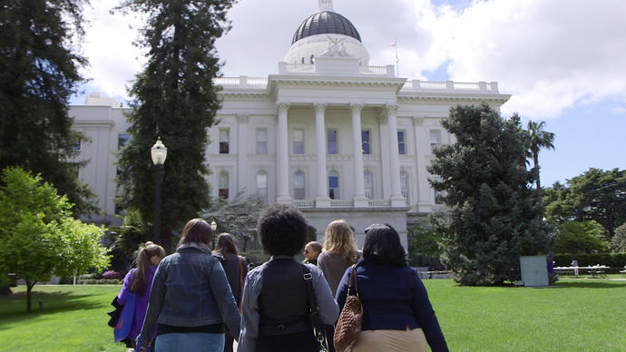 a group of activists walking towards The Capitol