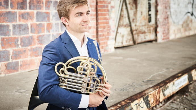 Ben Goldscheider looking into the distance with his French Horn