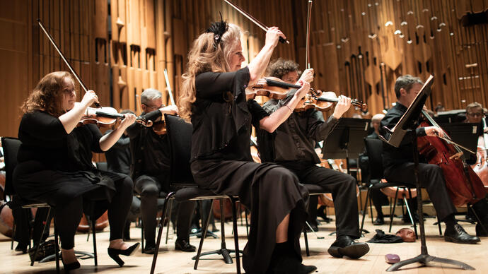 Some of the member of Britten Sinfonia on the Barbican stage
