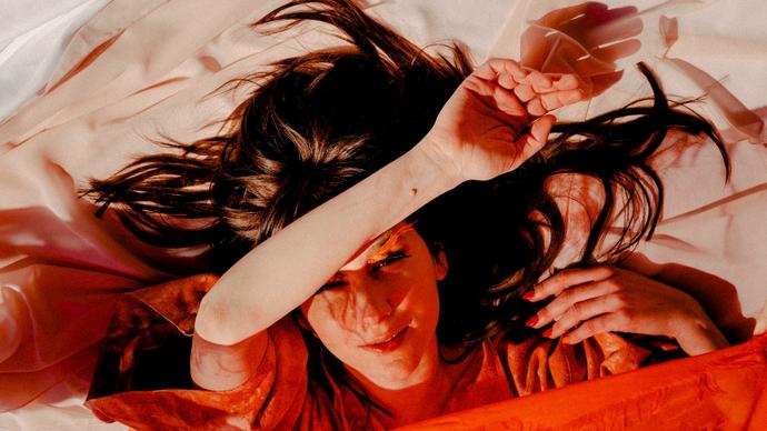 colour photo of Circuit des Yeux wrapped in orange sheets