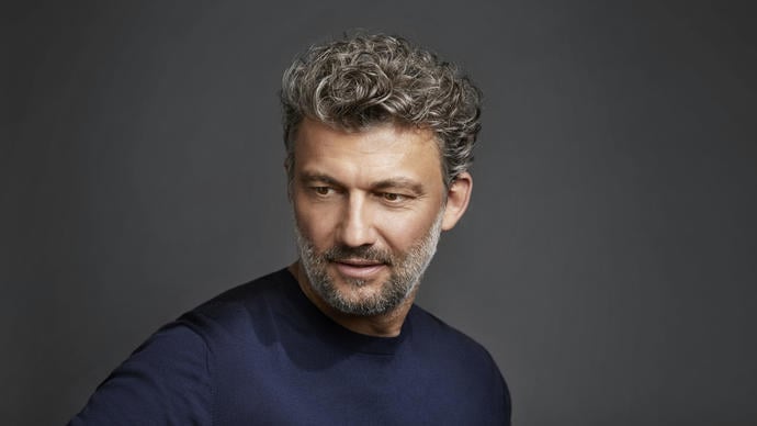 Jonas Kaufmann sideways on to the camera, looking backwards over his right shoulder