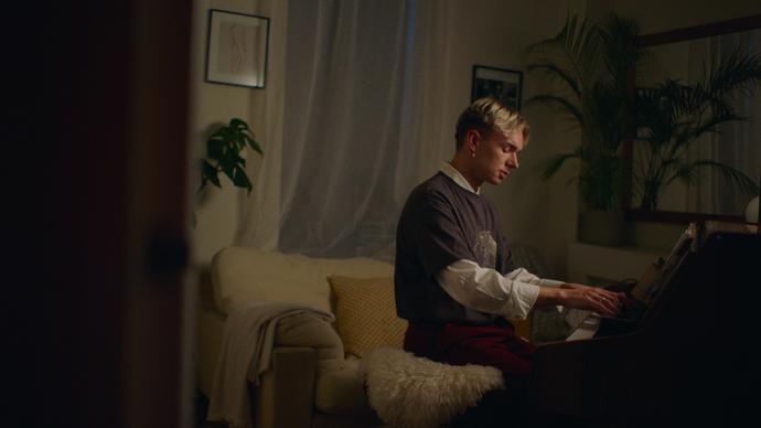 a photo of Douglas Dare playing piano at home