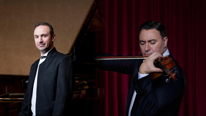 In the left of the image Simon Trpceski stands smiling in black tie in front of a piano. In the right of the image Maxim Vengerov is playing his violin.