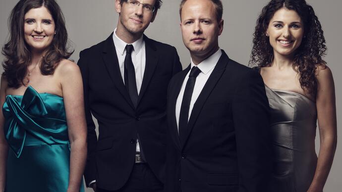 Photo of Carducci Quartet in formal dress smiling at the camera