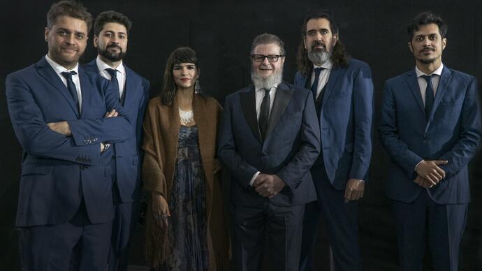 A portrait of Gustvao Santaolalla and his band