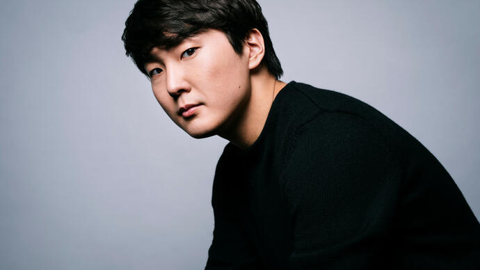 Seong-Jin Cho looking at the camera against a white background