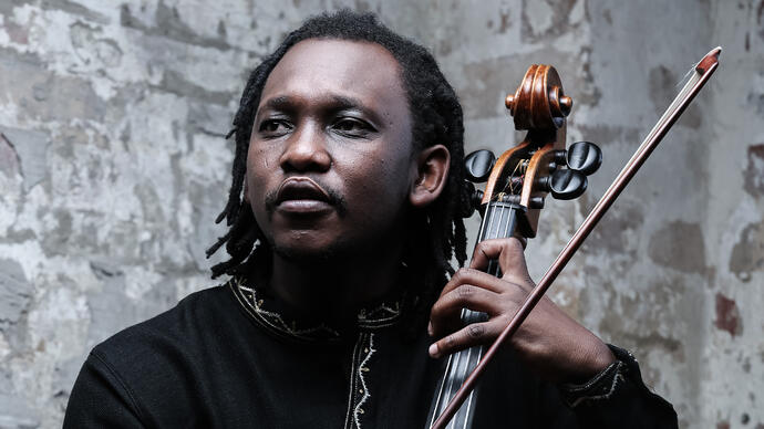 Abel Selaocoe holding his cello