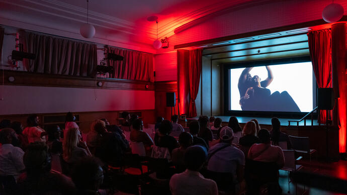 Audience watching a film on an elevated screen